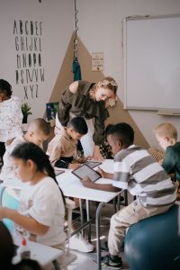 Young students seated in a small classroom group, engaged in a collaborative learning activity at Archers College in Roodepoort.